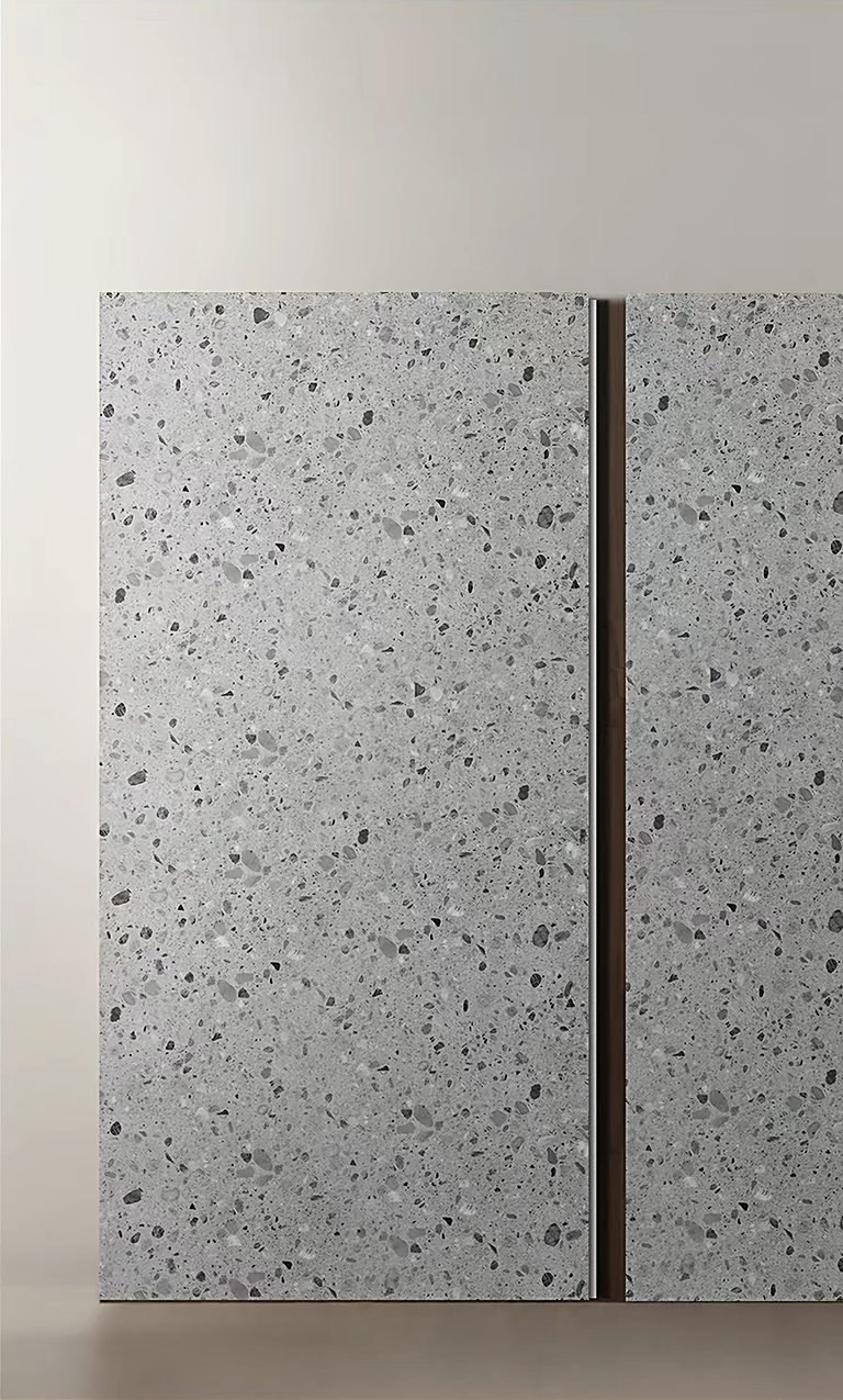 Grey speckled panel with a terrazzo-like surface.