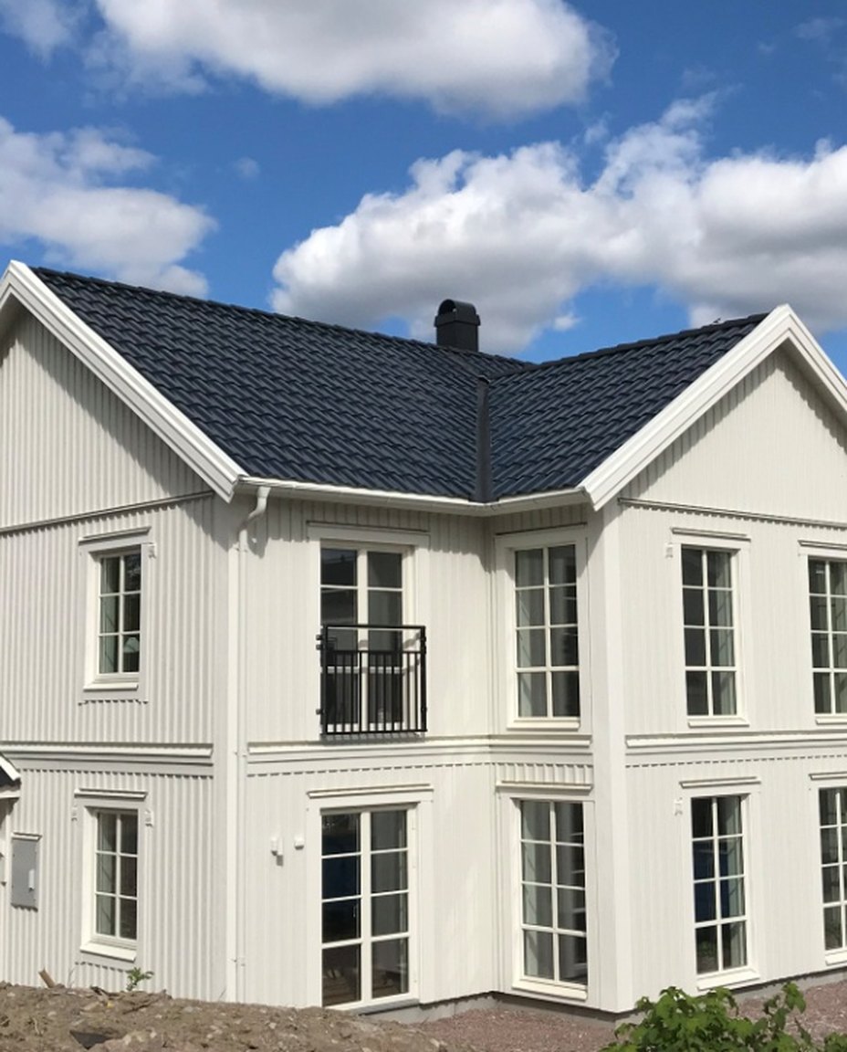 A house roofed entirely in dark solar tiles