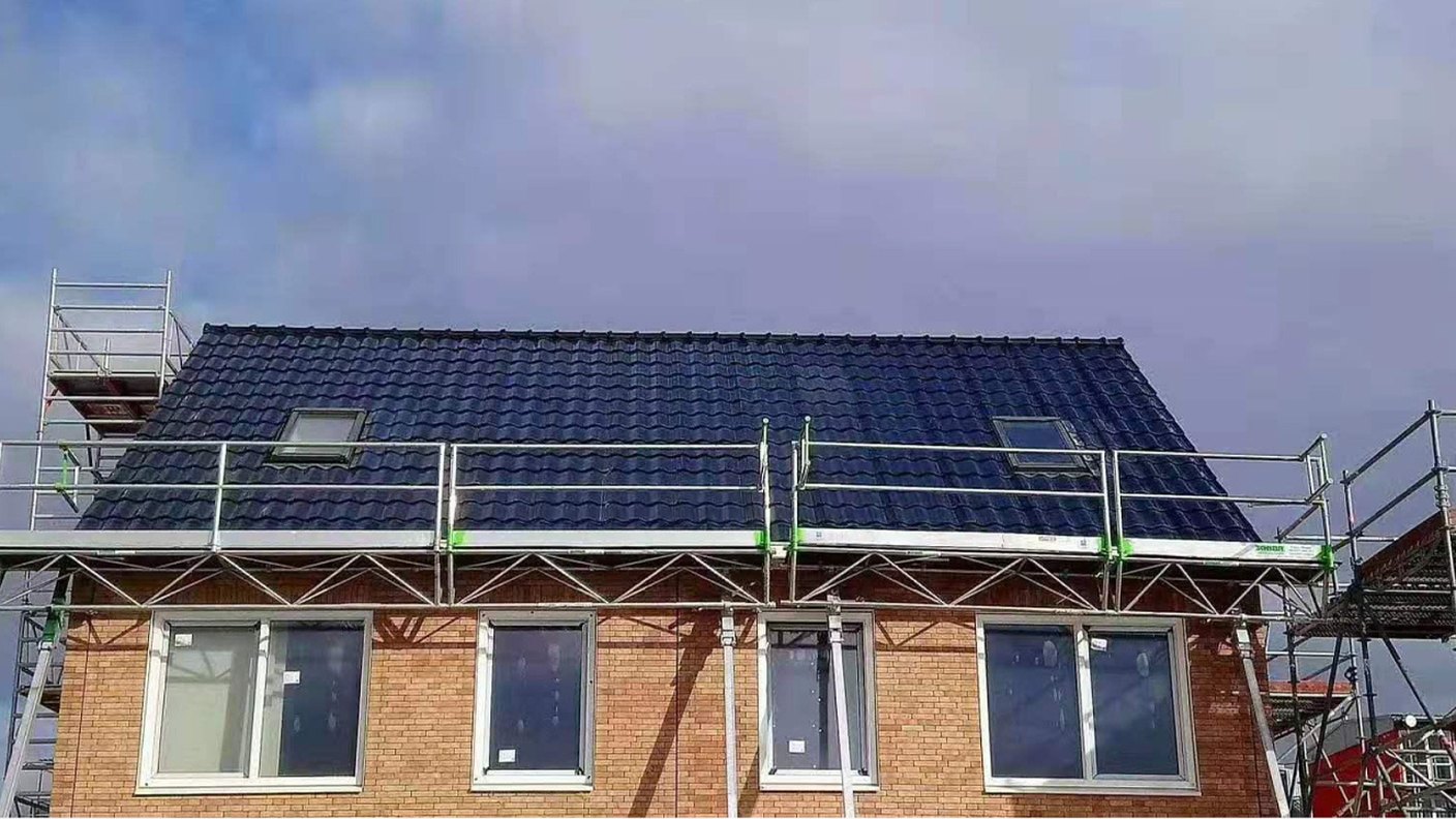 Solar tiles being installed course by course on a pitched roof